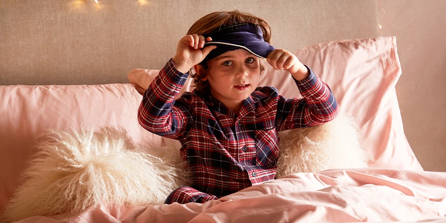 Child waking up, removing eye mask