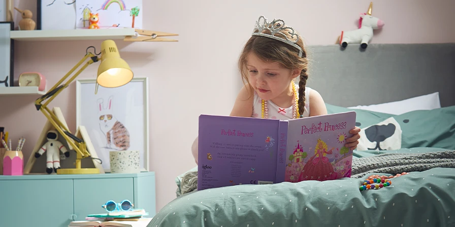 Little girl reading a bed time story