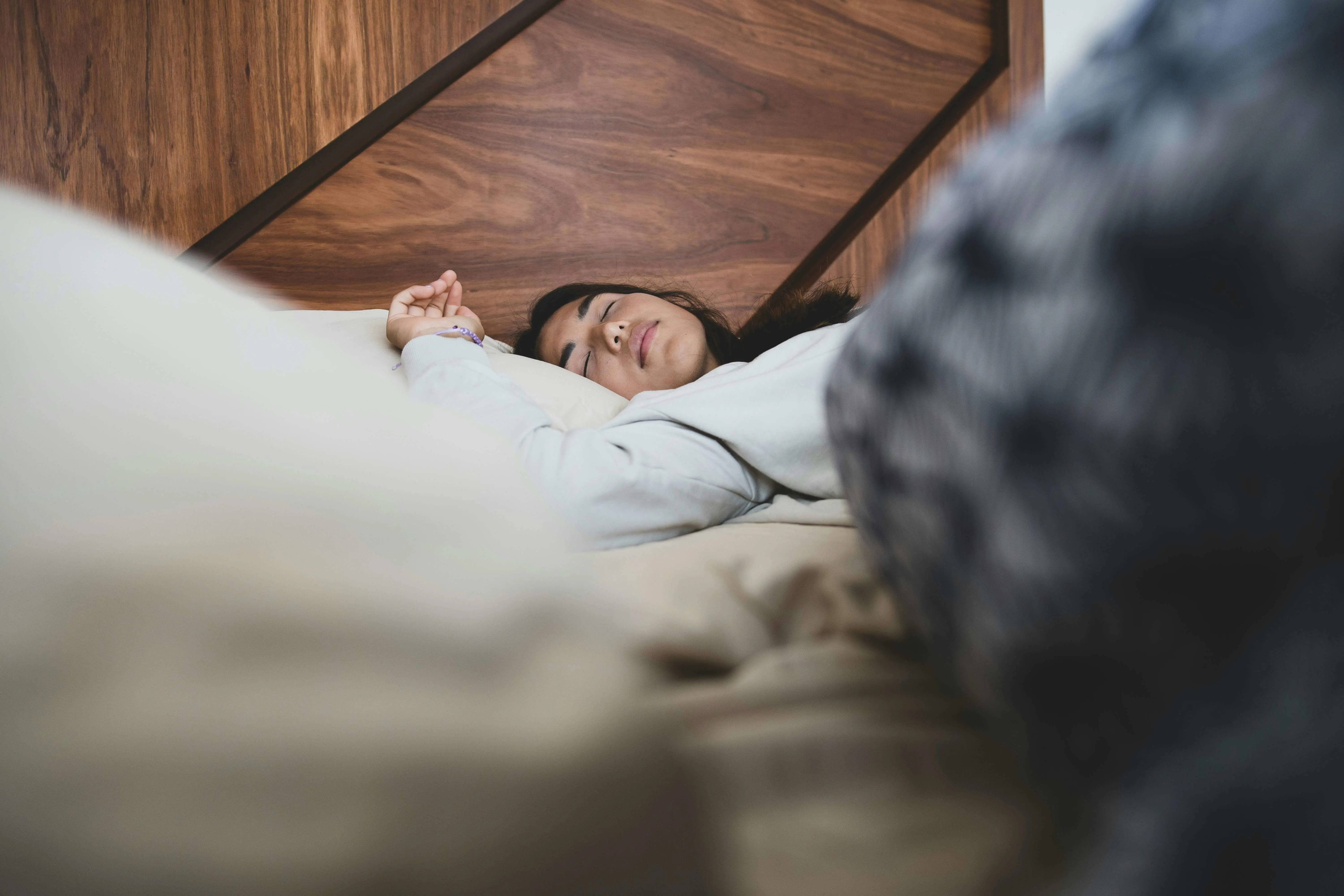 Woman sleeping in a clean bed, having followed a good hygienic bed routine. 