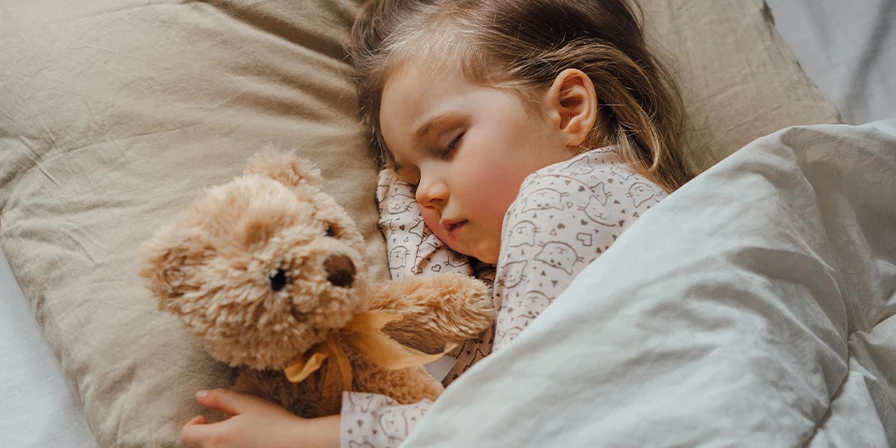 Child sleeping with a teddybear