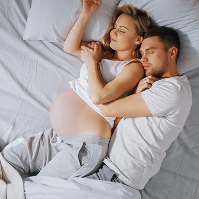Sleeping pregnant woman and partner