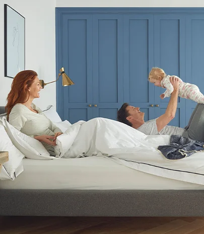 family in bed laughing