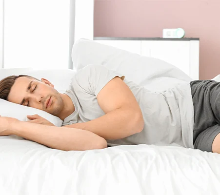 Man sleeping on his side in bed