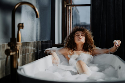 Woman taking a relaxing bubble bath