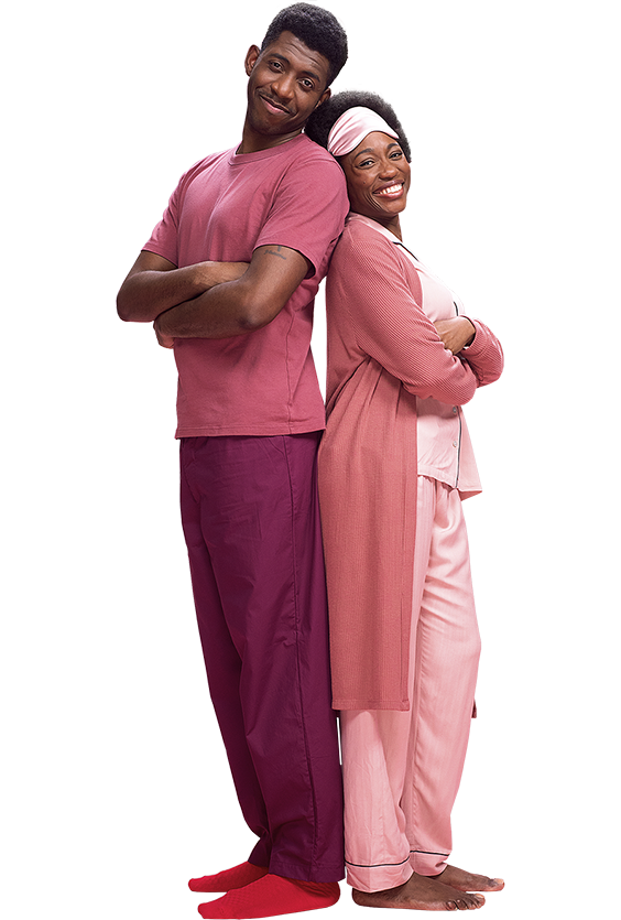 A couple standing back to back in pink Pyjamas