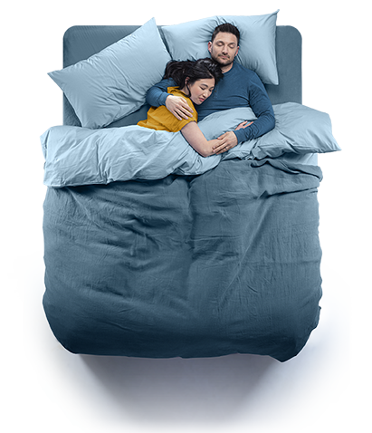Top down view of a couple sleeping in a Silentnight Geltex bed. Blue