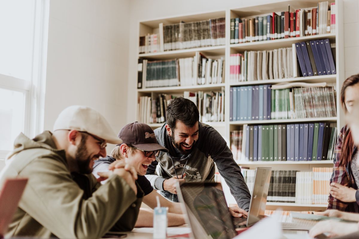 A group of coworkers enjoying working together on laptops 