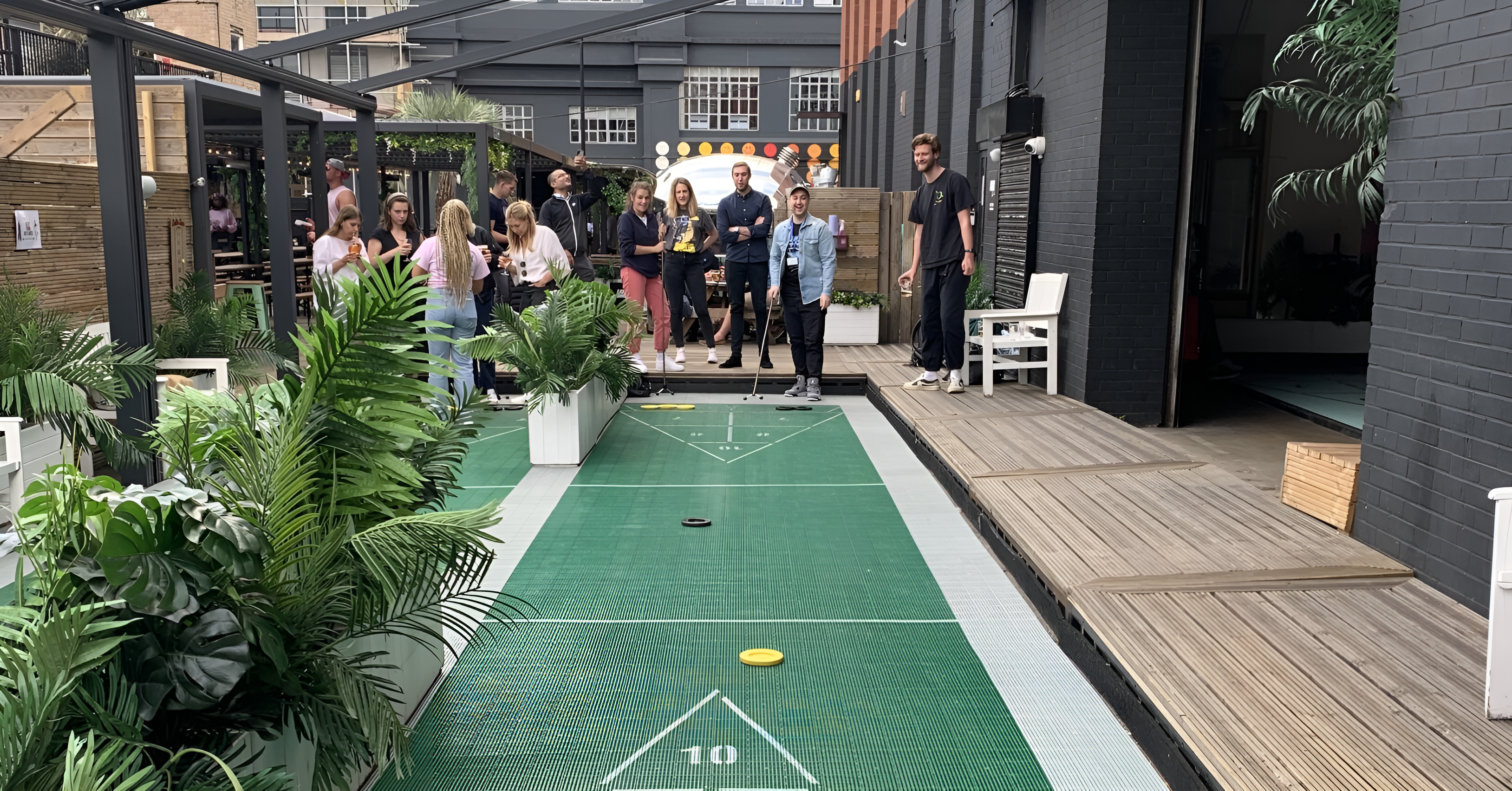 The Member Engagement Marketing team playing shuffle board during their Summer team social 