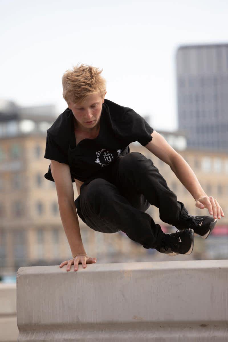 En kille hoppar över ett hinder i parkour.