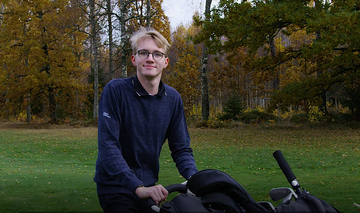 Erik Lagerlöf drar sin golfvagn framför sig på banan.