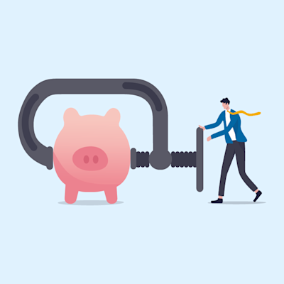 man squeezing a piggy bank
