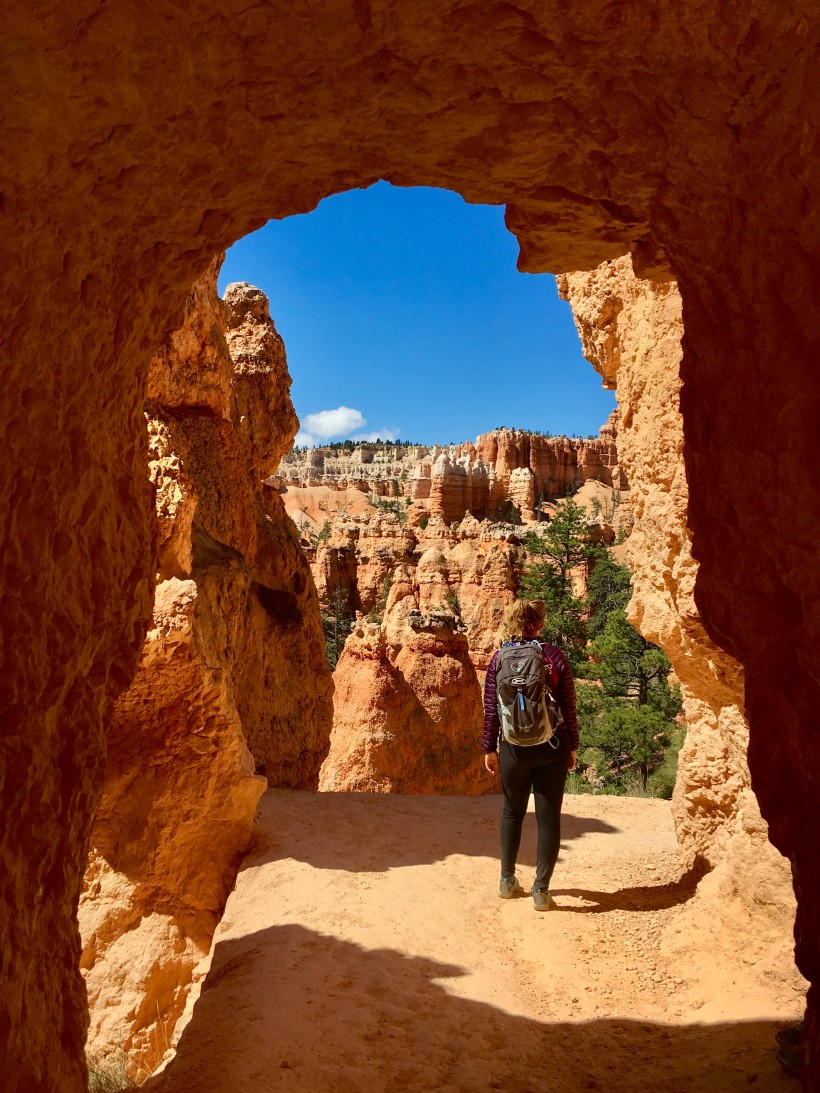 AdventureTripr's Marketing Manager Kirsten exploring a natural arch in Bryce Canyon National Park.