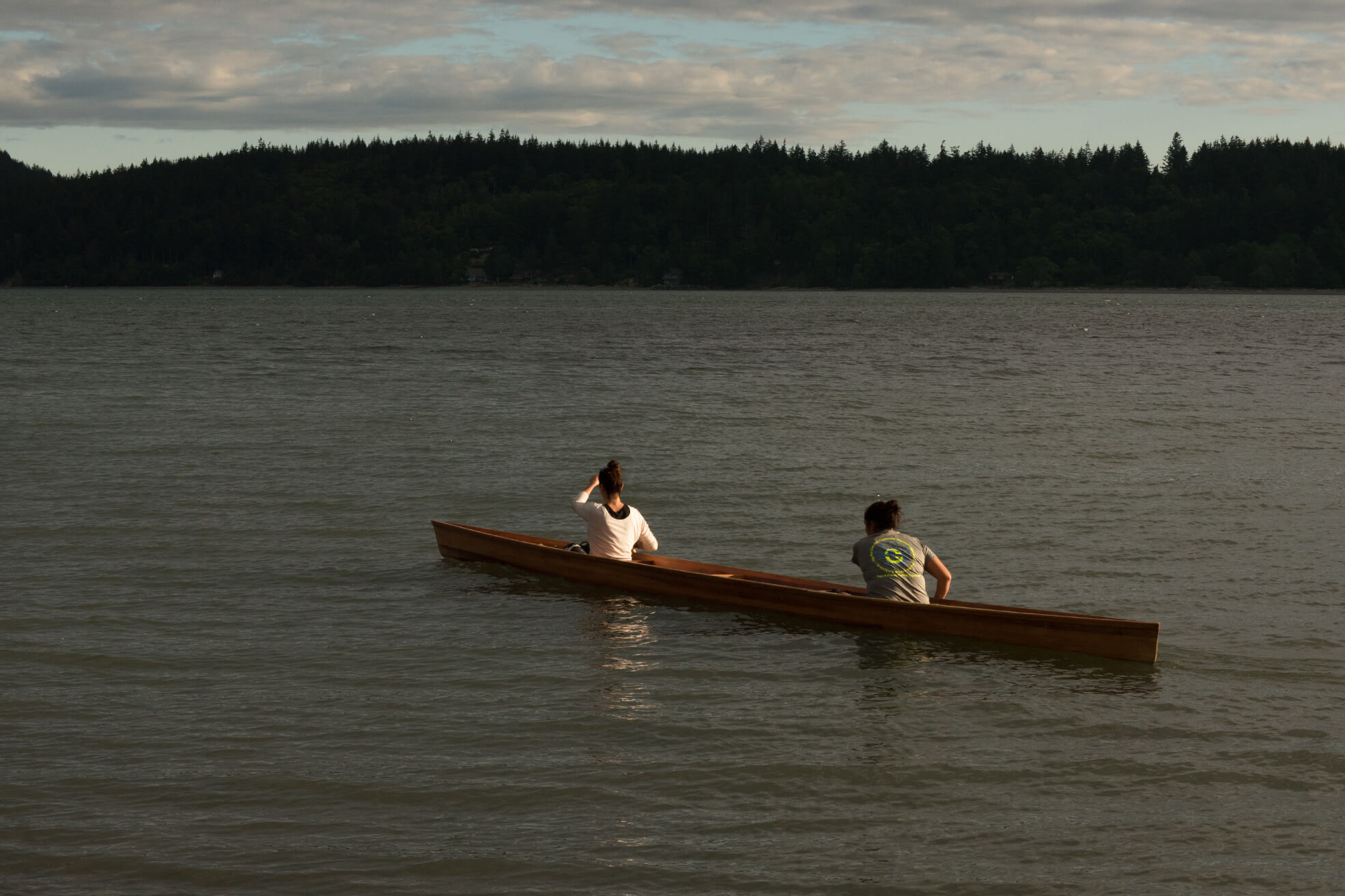 Still from Daughter of a Lost Bird. Two people row a boat on a lake.