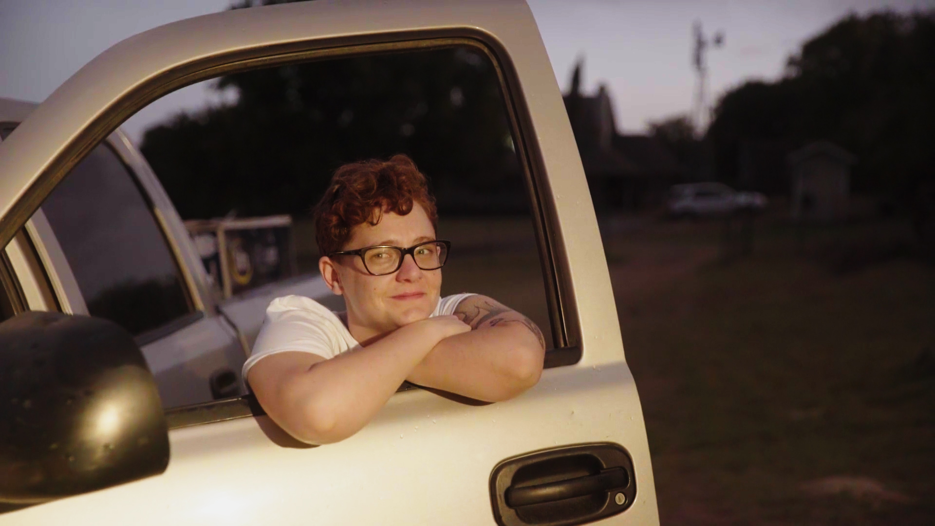 A photo of Cody Stickels peeking through the window of a pickup truck.