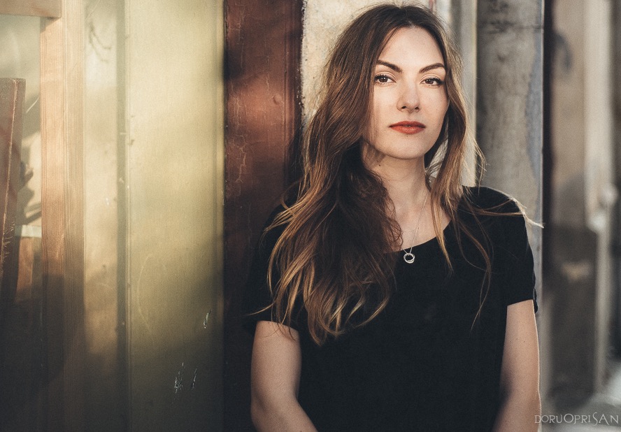 Portrait of a woman wearing a short sleeve shirt and looking directly at the camera.