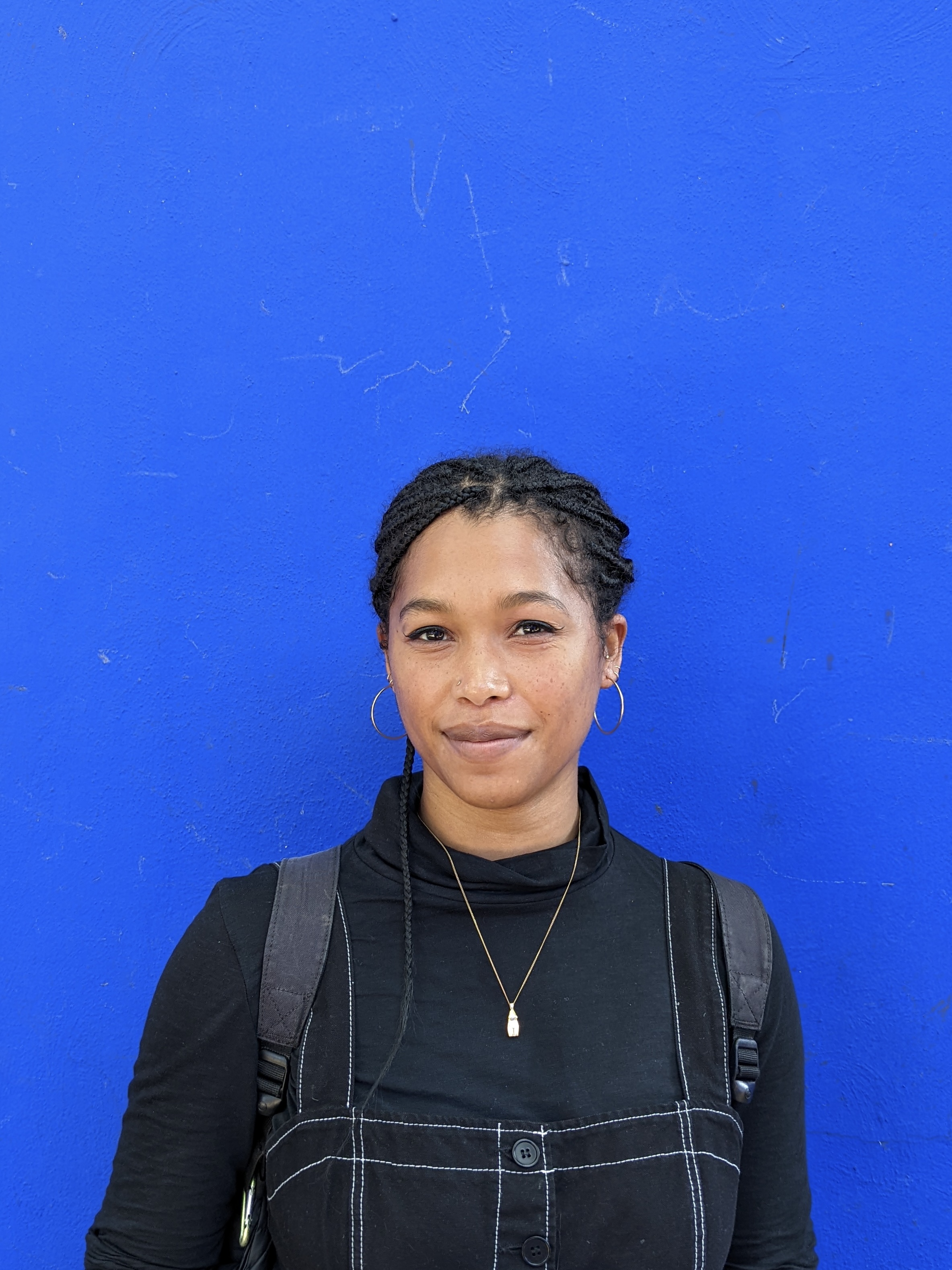 A photo of Hyacinth Parker in front of a blue background.