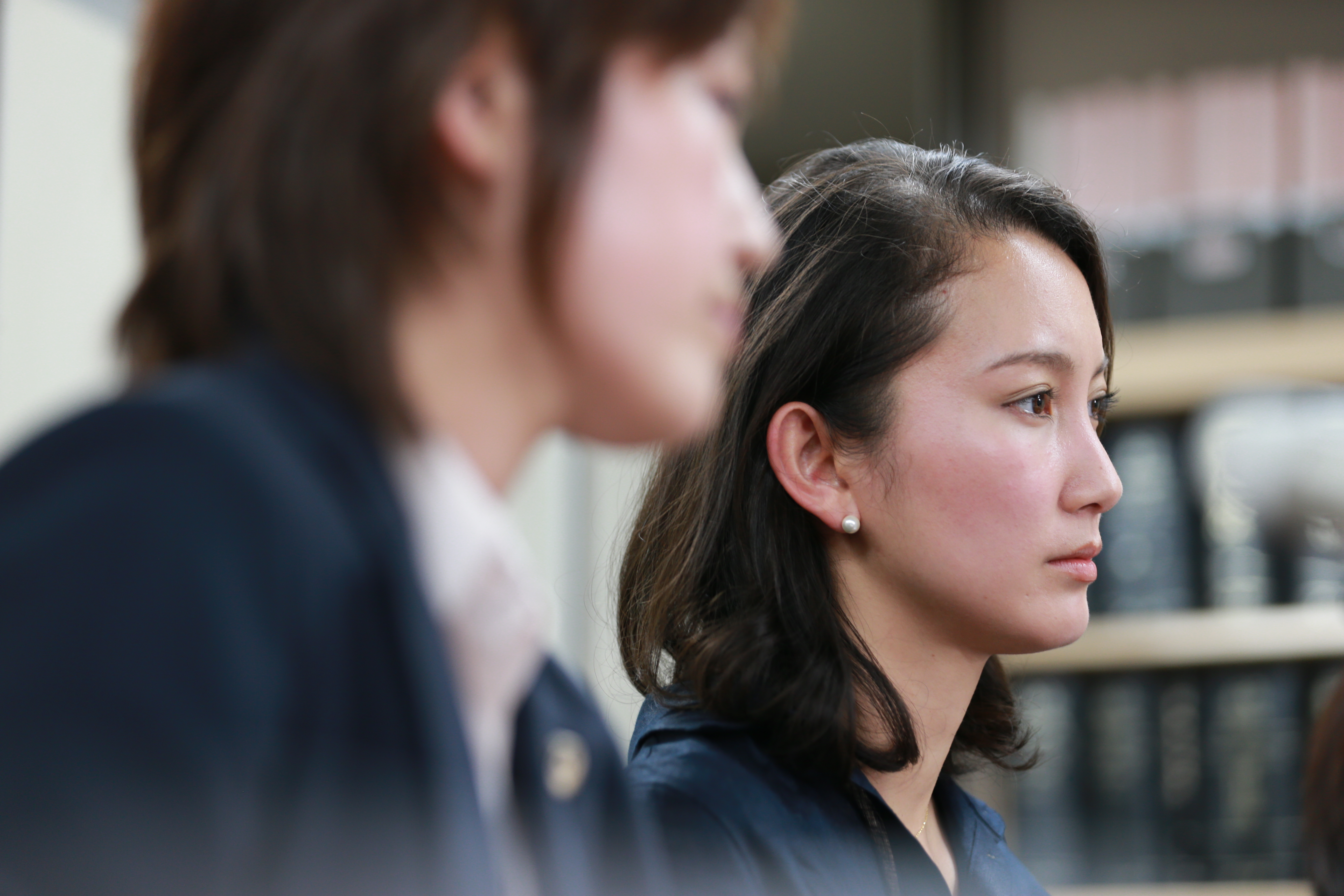 Still from Black Box Diaries. Two women, one is out of focus, looking to the side. 