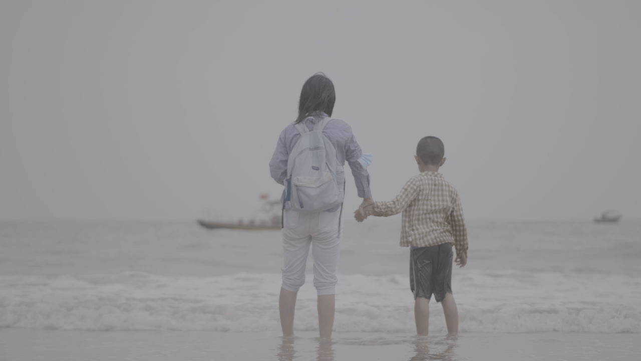 Main characters in The Total Trust standing in front of the ocean.