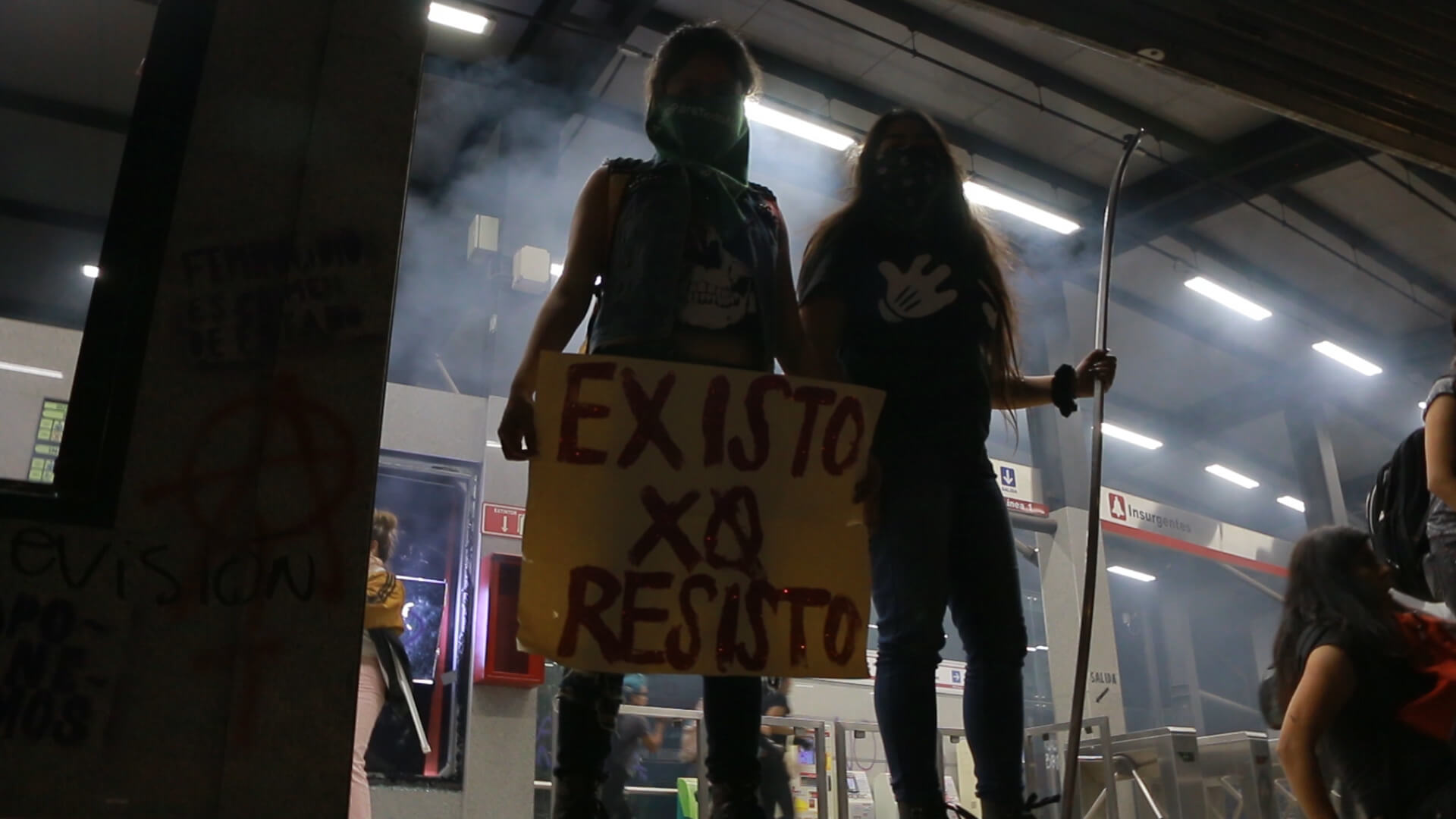 Hundreds of women protest after three women, two of them minors, were raped by police officers, by painting walls and breaking glass at the Glorieta de los Insurgentes, a landmark in Mexico City located in front of the Secretariat of social Security. In the picture we can see two young women with a banner that says "I exist because I resist".