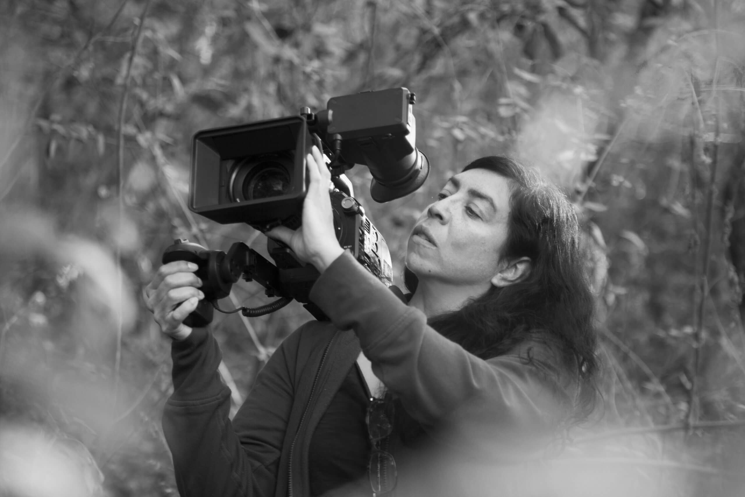 Tatiana Huezo taking a video with a large camera