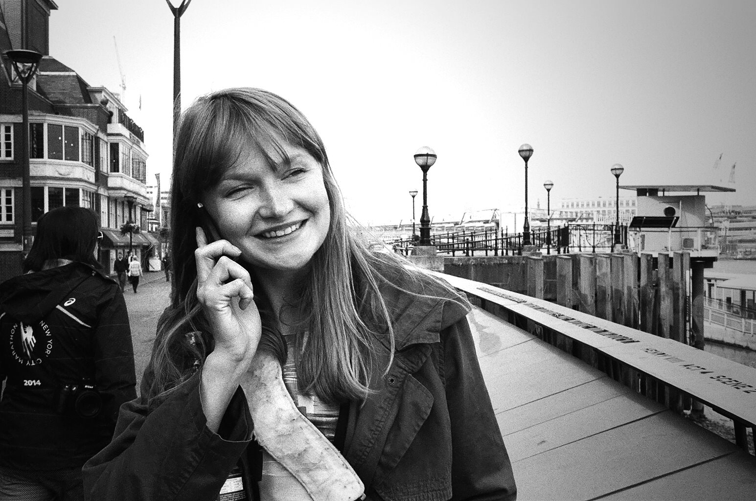 Portrait of director Maris Salumets while talking on a cellphone.