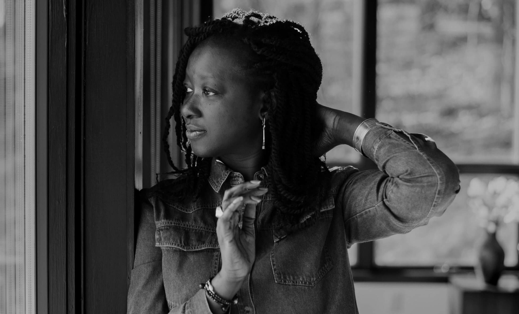 Black and white portrait of Katy Léna Ndiaye. Katy looks away from camera.