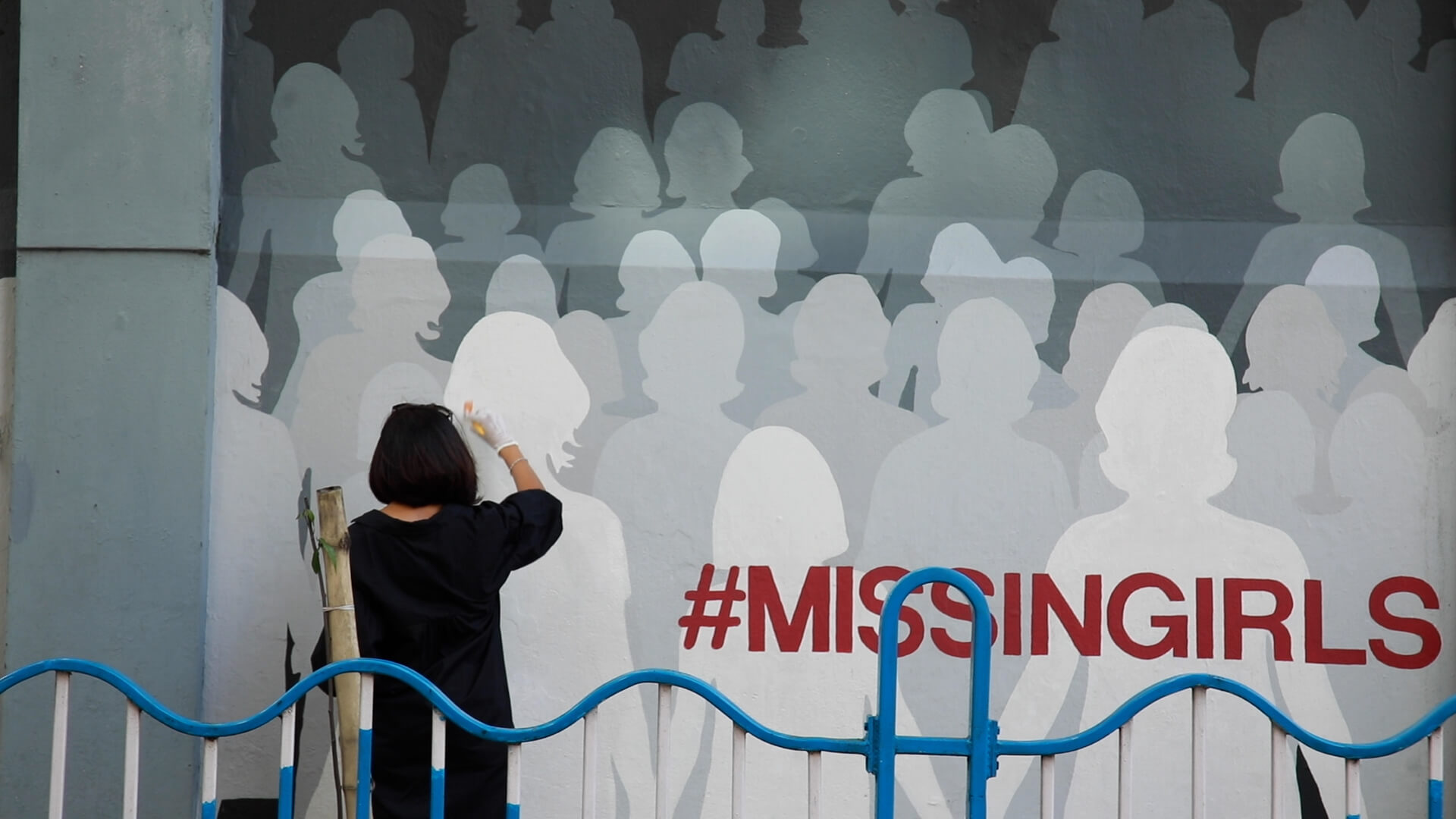 An artist relentlessly sprays public walls with life-size shadows of girls tagged #missing