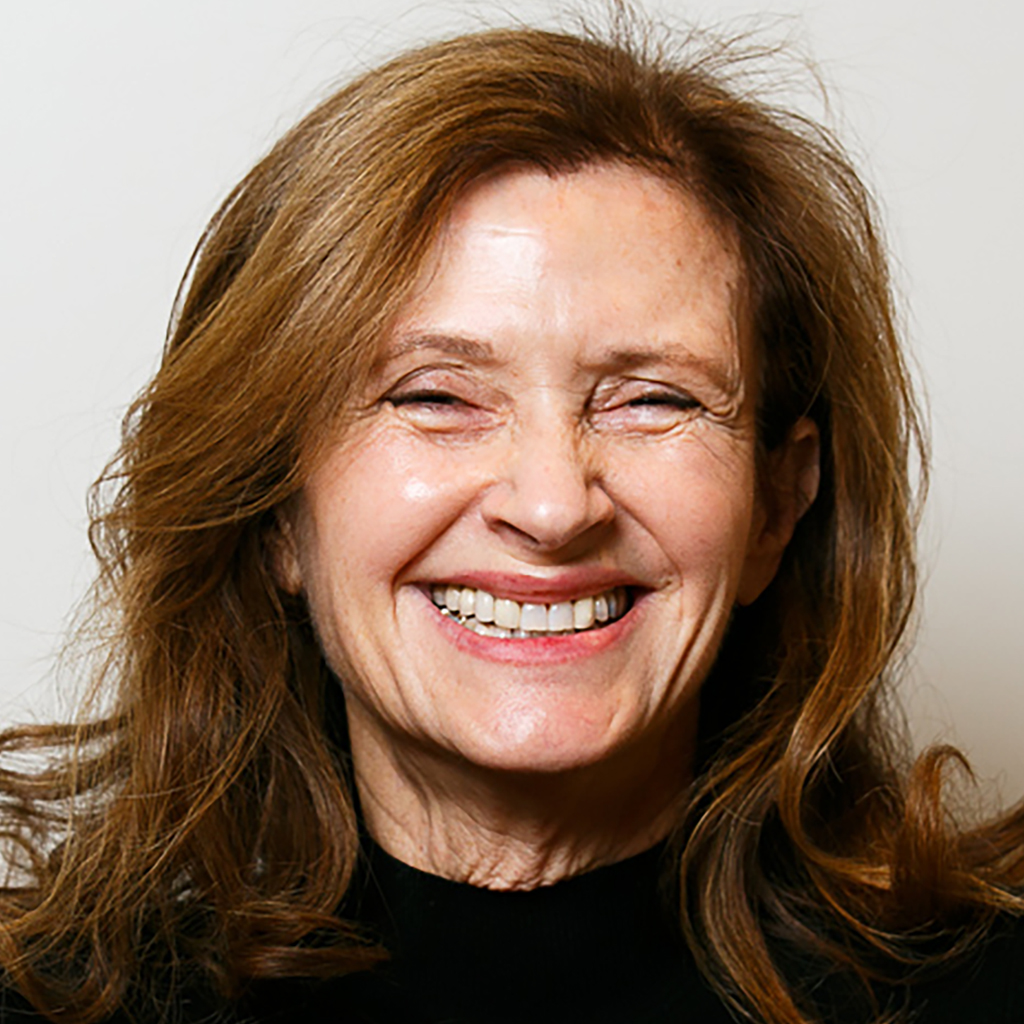 headshot of co-founder Wendy Ettinger. Wendy looks directly at the camera and smiles. She wears a black long sleeved sweater. 