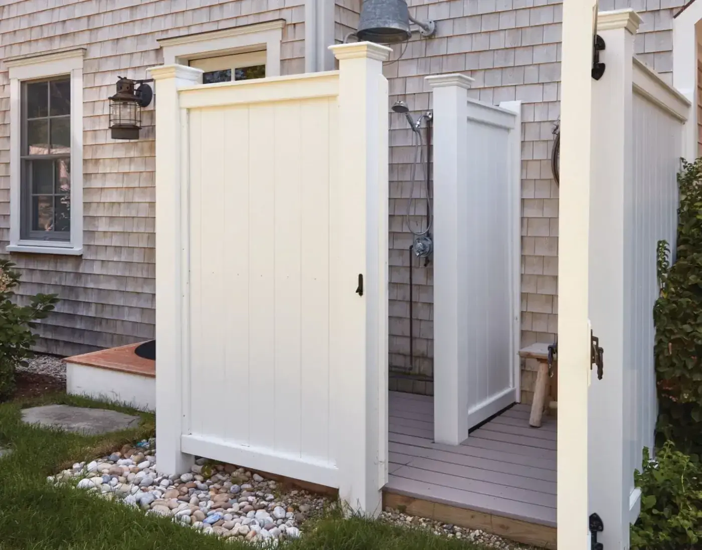 A simple enclosure you can attach to your house, cabana or garage, this shower enclosure is designed to attach with cleats (supplied) to a vertical wall. With a separate changing area, the ultra-roomy Chatham has all the showering comforts of indoors. Solid Cellular Vinyl is an advanced, low-maintenance vinyl material that is impervious to water and won't warp, rot or split. Solid Cellular Vinyl enclosures come standard with 1" x 6" tongue and groove Solid Cellular Vinyl board construction, 5 1/2" sq. posts with Westport post caps, a panel height of 6' and a white, factory pre-finish. Hardware includes black powder coated, galvanized heavy reversible strap hinges and ring latch. 77¾" H, 96"W, 74¼"D. Chatham Shower Decking sold separately.