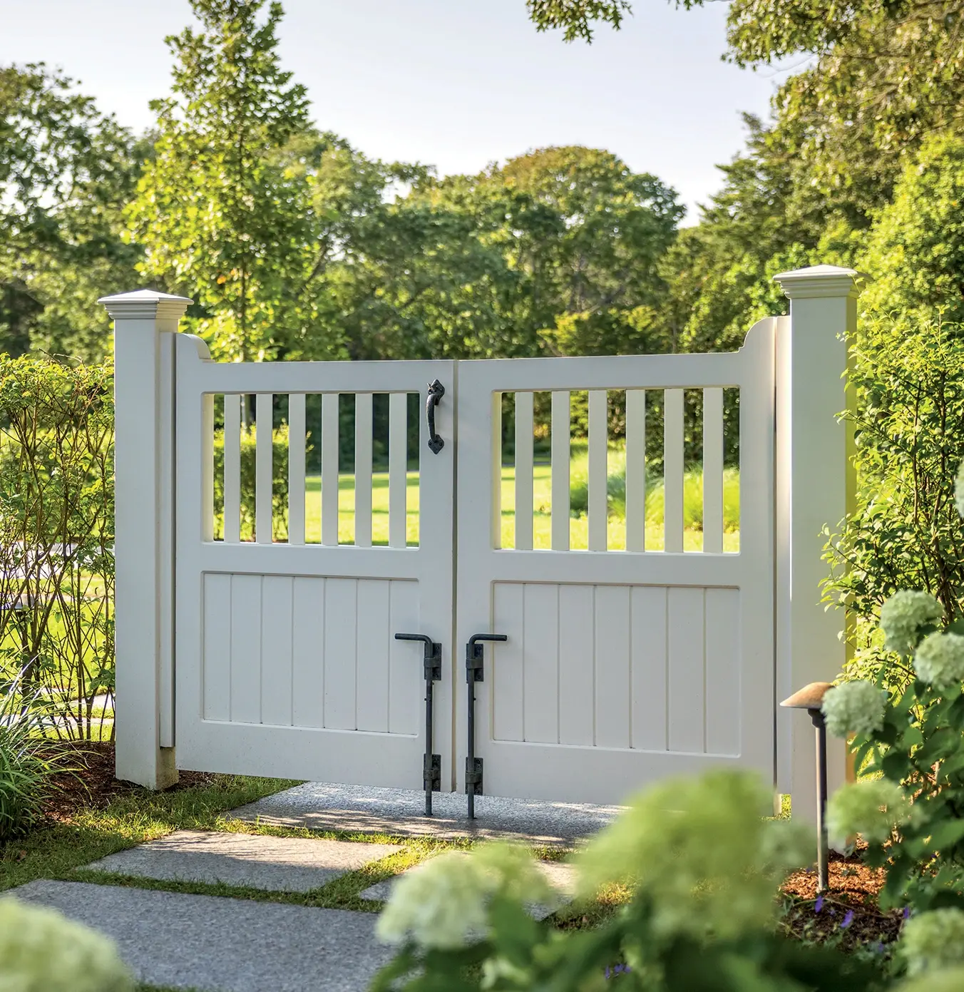 Capped Yorktown pickets meet an elegant board bottom to create this charming gate that provides greater privacy. Crafted in solid cellular vinyl and prefinished white. Double gate shown in photo.


