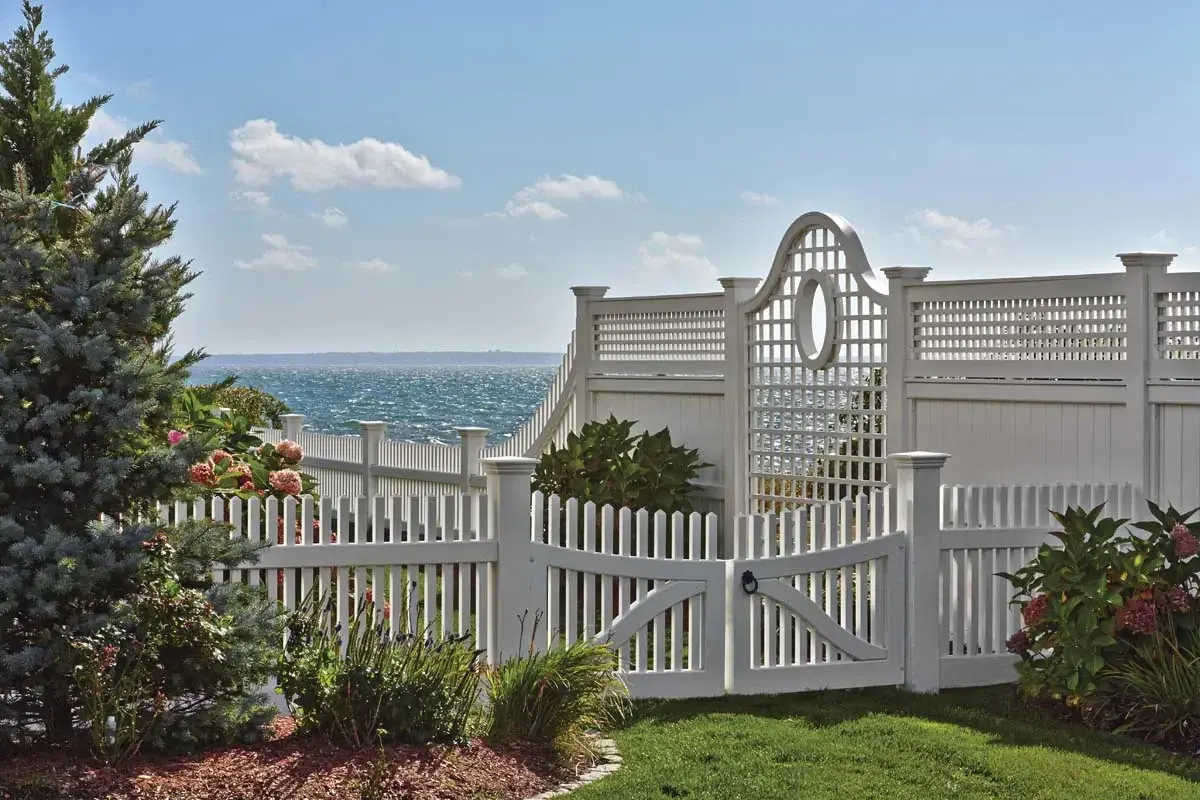 For a location by the water, this customer chose an open lattice panel section with a porthole-like oval cut-out. This is housed between a substantial Universal board fence. The topper matches the horizontal/vertical motif on the lattice panel. 