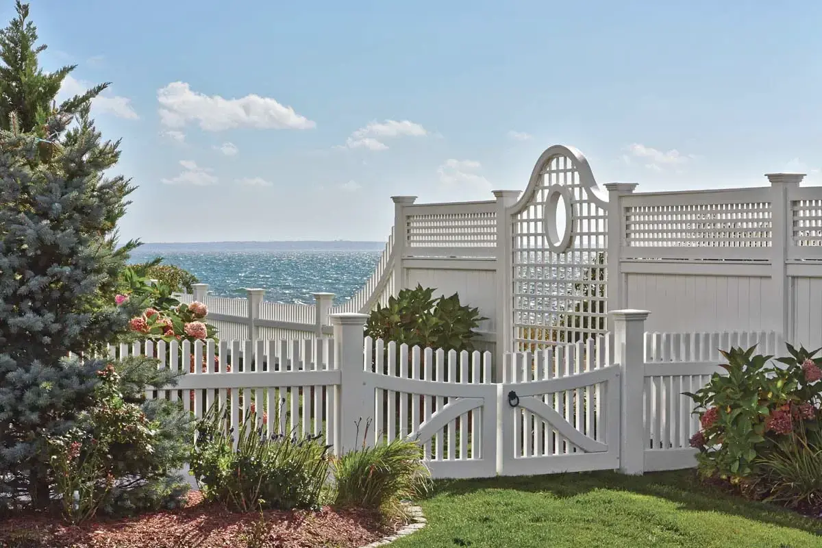 For a location by the water, this customer chose an open lattice panel section with a porthole-like oval cut-out. This is housed between a substantial Universal board fence. The topper matches the horizontal/vertical motif on the lattice panel. 