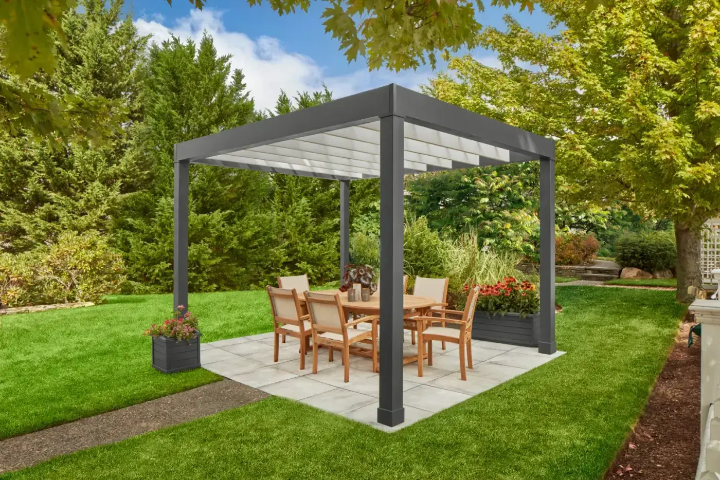 Create your own contemporary outdoor living space with the freestanding Lockhart Pergola. Crafted in solid cellular vinyl, square columns have a top trim and end with base kickplate. Factory finished in Iron Ore with Sherwin-Williams Super Paint and carries a 25-year warranty.