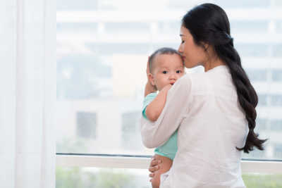 Mom kissing baby