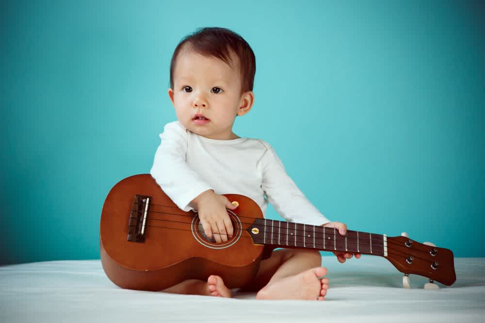 Baby playing guitar