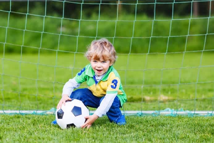 Toddler playing football