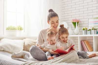Mother reading to daughters