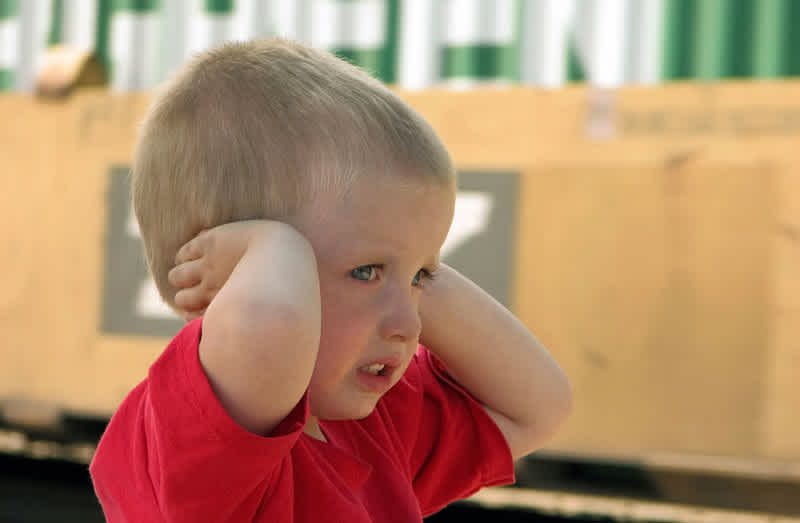 Boy covering ears