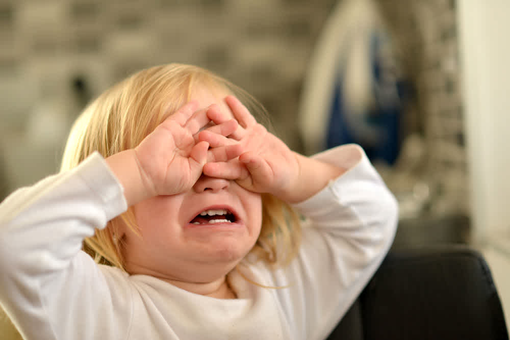 Little girl covering eyes