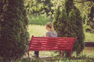 Woman on park bench reading