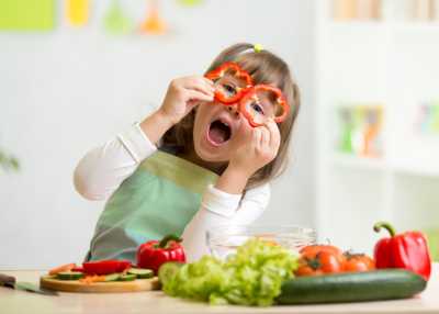 Little girl playing with veg