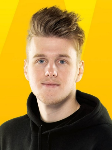 Lachlan smiling in front of gold background