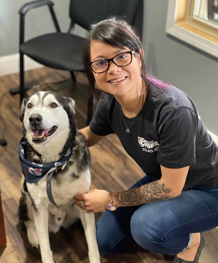 Catherine Keo with Din, the shop dog of The Original Plumber