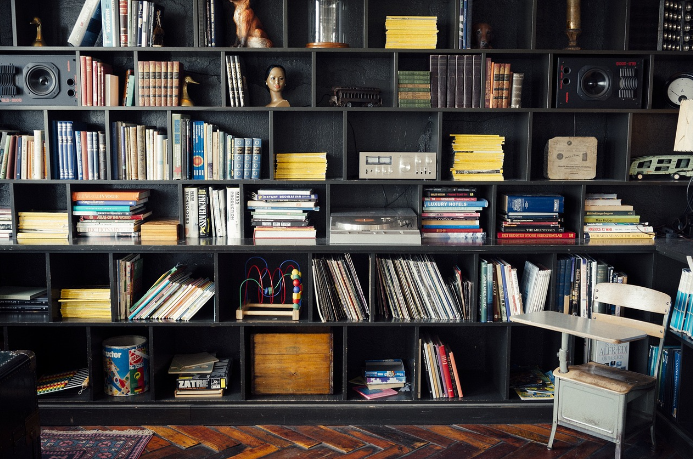 Home bookshelf with books, records, and personal items — used by Quashed to show what contents insurance can cover.