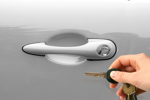 A hand holding car keys near a vehicle door handle, illustrating the moment of vehicle collection discussed in this 2026 Quashed guide.