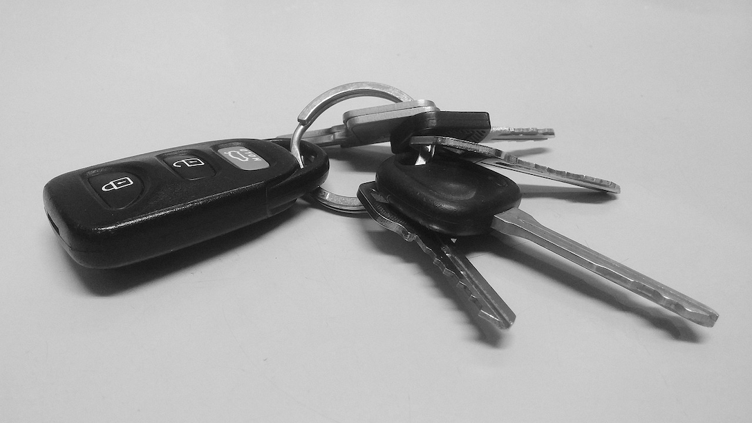 A close-up of car keys on a desk.
