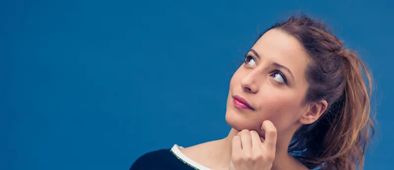 A woman thoughtfully considering her financial choices.