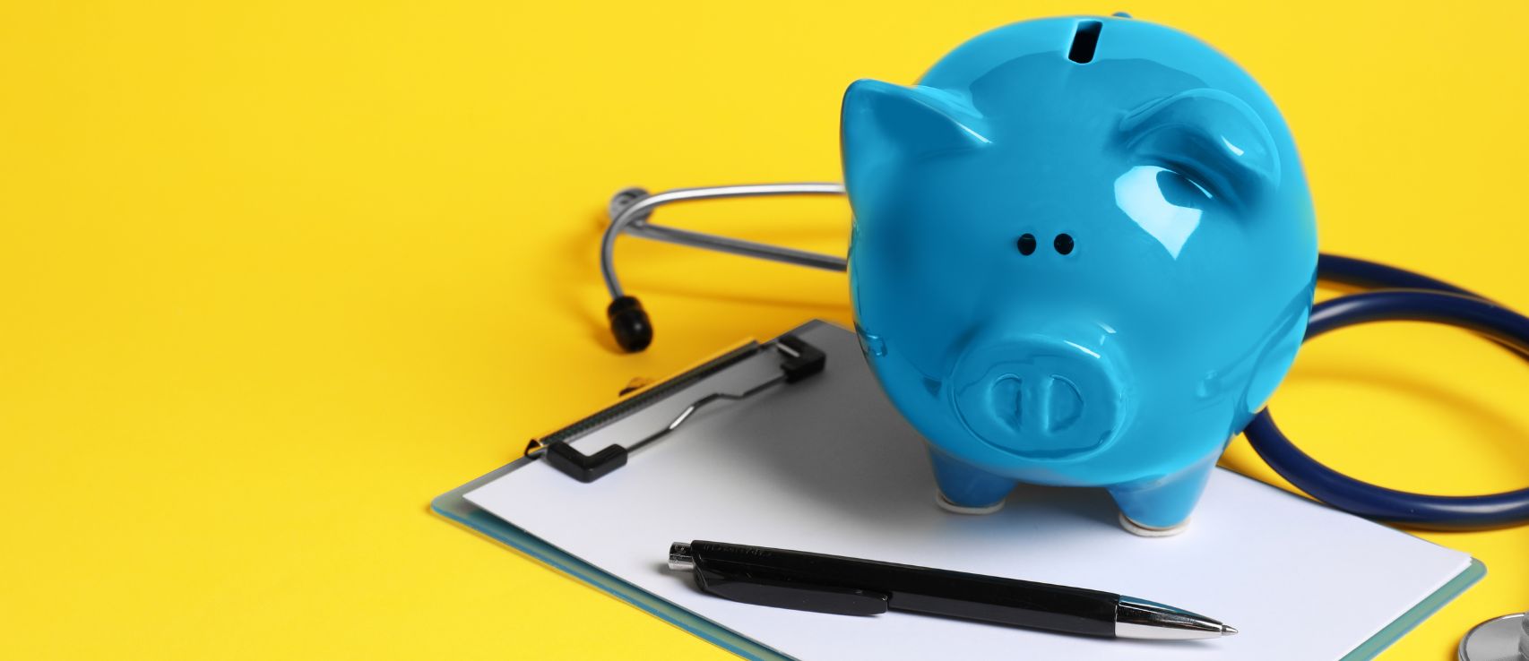 Blue piggy bank with stethoscope representing savings on Cove pet and car insurance, featured in a 2026 Quashed article.