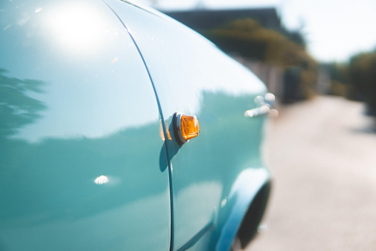 A close-up of a scuff on a light car caused by an automatic car wash in New Zealand.