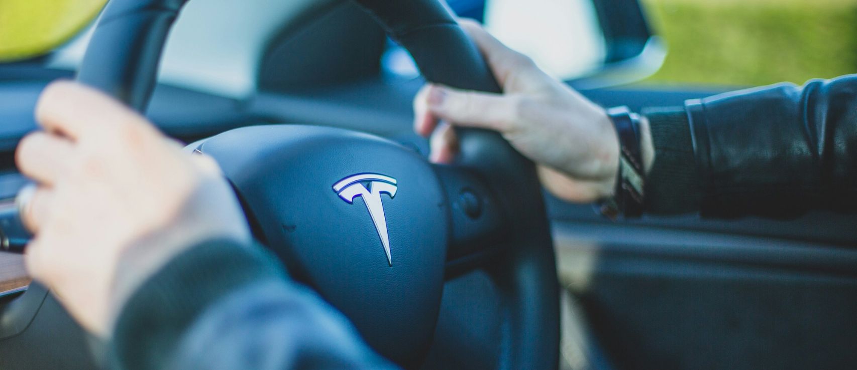 Tesla steering wheel featured in a New Zealand Tesla car insurance 2026 guide to Model 3 and Model Y premiums by Quashed.